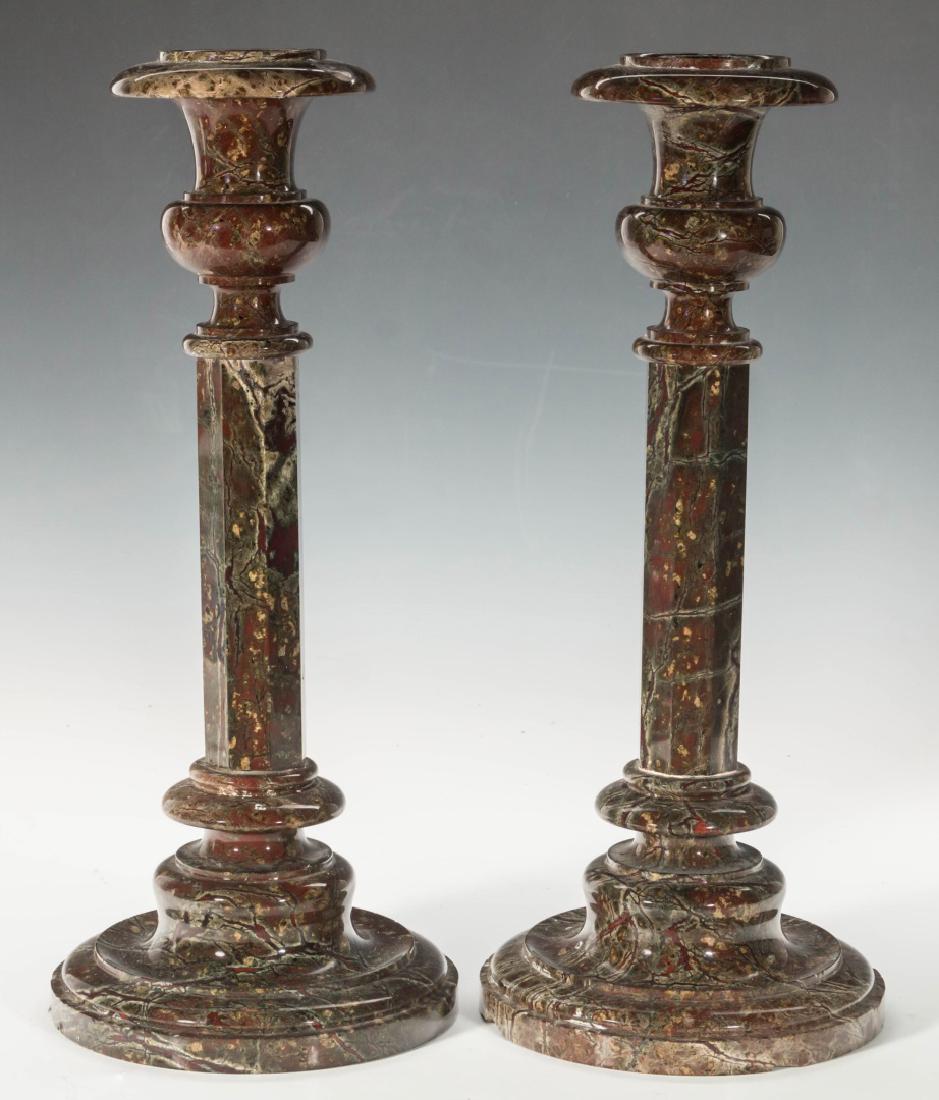 PAIR LATE 19TH TO EARLY 20THC. MARBLE CANDLESTICKS: Each on circular stepped base, nicely colored range of marble, the knopped standard with paneled hexagonal shaft supporting urn-shaped candle cups. Measure 13.75 x 5.75 inches each.