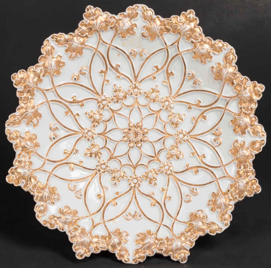 A LATE 19TH CENTURY MEISSEN PORCELAIN PLATE: Embossed designs of leaves and vinery enhanced with gold. Blue crossed swords mark under the glaze. Measures 2 x 10.75 inches.