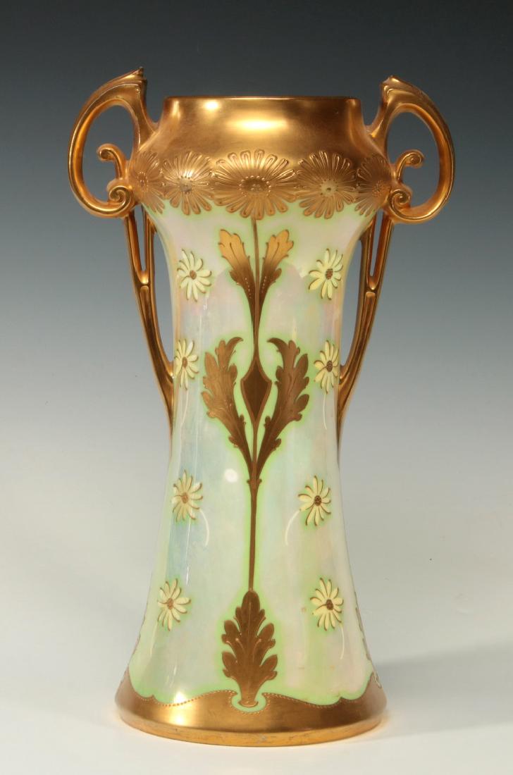 AN ART NOUVEAU INFLUENCE HAND PAINTED PICKARD VASE: A Pickard China vase signed on the base with stamped over glaze mark from the period 1898-1903, unusual openwork handles and flower heads in raised enamels on lustre ground. Measures 13.75 x 8 inches.