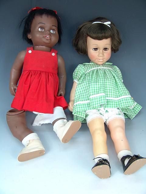TWO CHATTY CATHY DOLLS INCL. BLACK. BOTH AS IS: Both as is. On left, the legs are loose, their sockets are broken out and the body looks to have been glued, on the right, the head is totally loose and how it could be repaired is unknown.