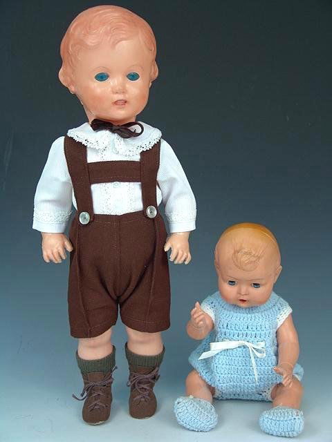 THREE LATE CELLULOID TYPE BOY DOLLS: Three plastic dolls made of a material that is similar to celluloid but from a different vintage. The standing boys are 17.5 inches and the sitting baby is 8 inches.