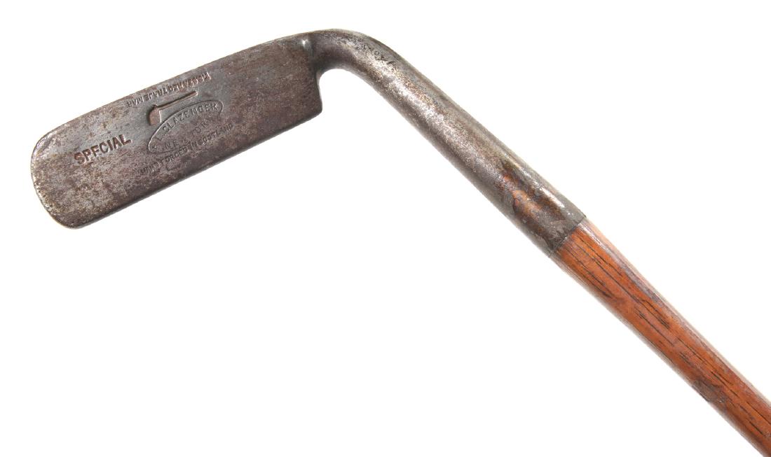 A SLAZENGER NEW YORK SMOOTH FACE SPECIAL ODD SHAPE: A hickory shaft golf club of unusual form. Measures 36 inches in length. We happily provide seamless in-house packing and shipping services on nearly everything we sell.