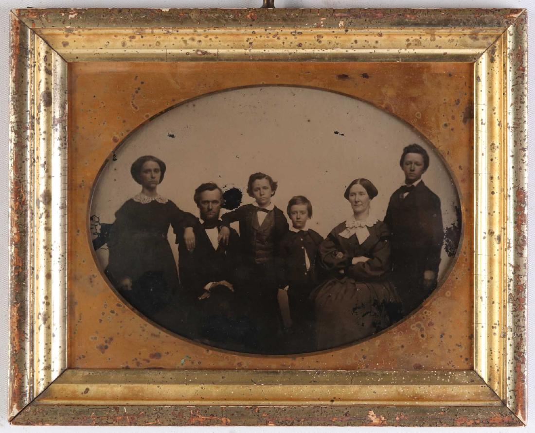 A FULL PLATE AMBROTYPE IN ORIGINAL PERIOD FRAME: A family portrait circa 1850 displayed in a water-gilded cove molded frame of the period, most likely the original. Measures 6.75 x 8.5 inches, 8.25 x 10 inch frame. We happily provide seamless in-hou