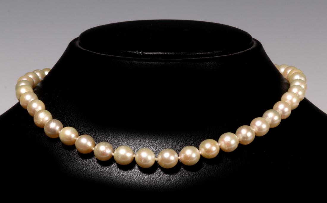 A NICE VINTAGE PEARL CHOKER LENGTH NECKLACE: Forty-three round pearls measure 8 mm each, clasp marked for 14 kt gold, necklace length 15.5 inches. We happily provide seamless in-house packing and shipping services on nearly everything we sell.