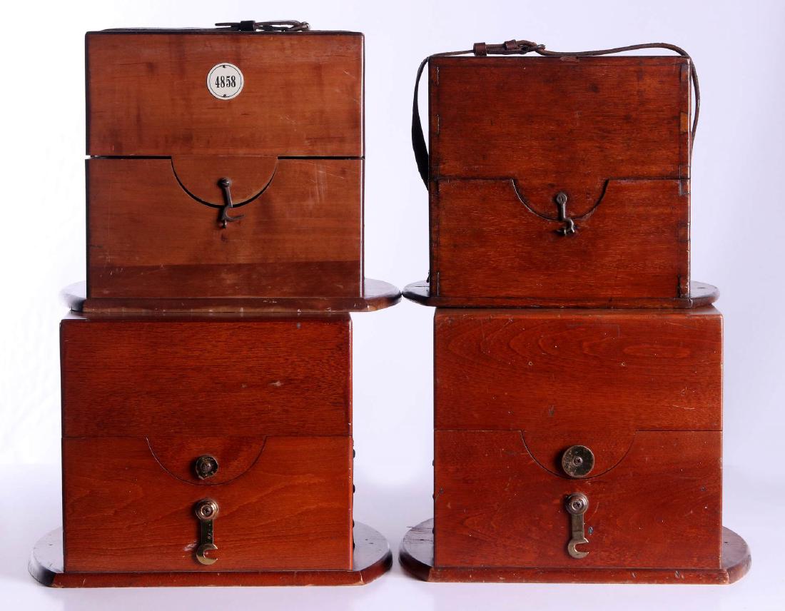 FOUR 20TH CENTURY MAHOGANY CHRONOMETER CASES: Two that measure 8 x 8.25 x 8.75 inches inside, 9.5 x 10.5 x 12.5 inch exteriors, one approximately 7 x 7 x 7 inches inside, 9 x 9 x 11 inches exterior. 'Ulysse Nardin, Le Locle (Suisse), with 4858 ta
