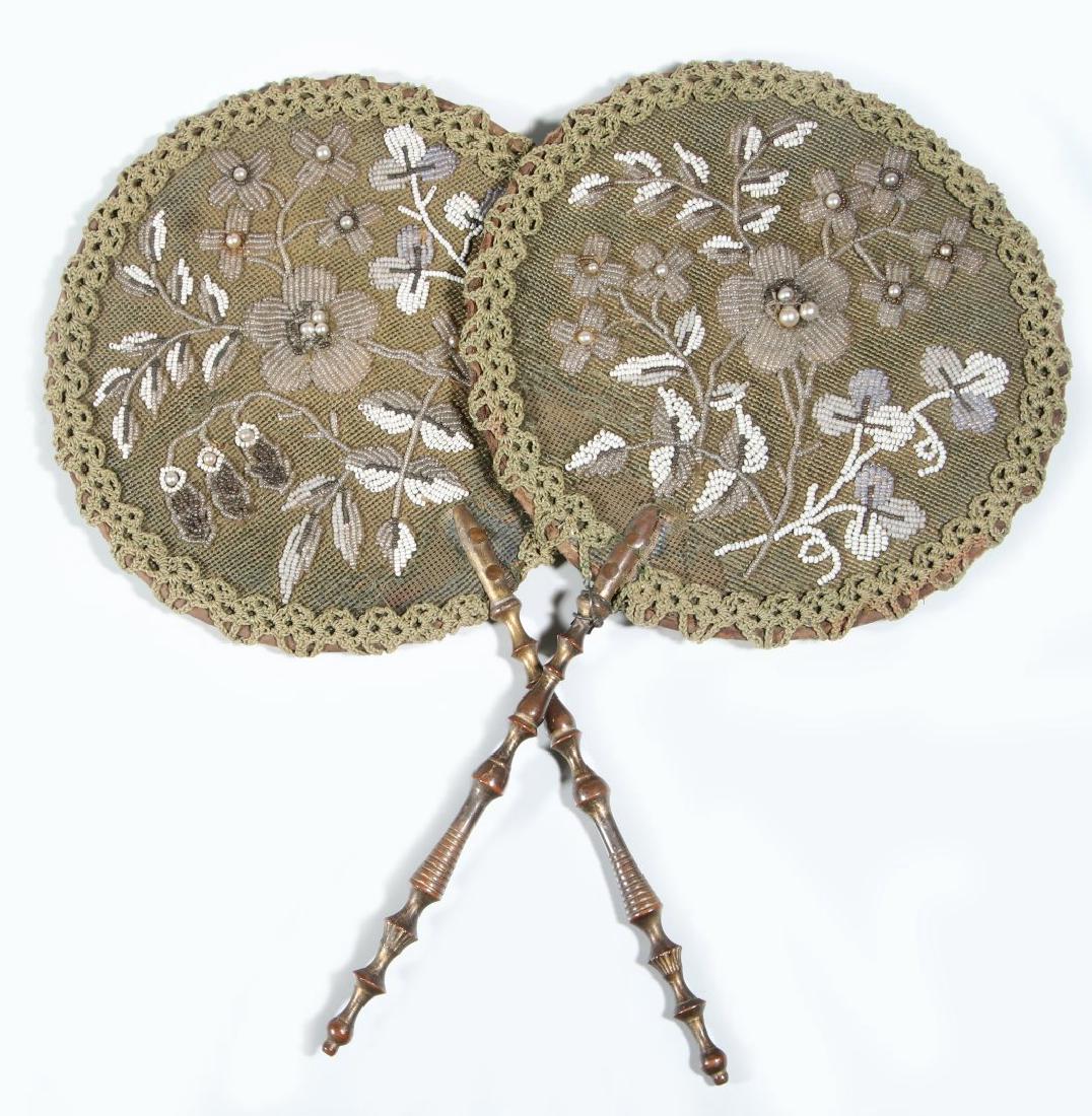 TWO 19TH CENTURY BEADED FACE SCREENS: Each with turned wood handle, beaded screens with crochet edging, brocade panel on the opposite side. Measures 17.25 x 9.25 inches each. We happily provide seamless in-house packing and shipping servi