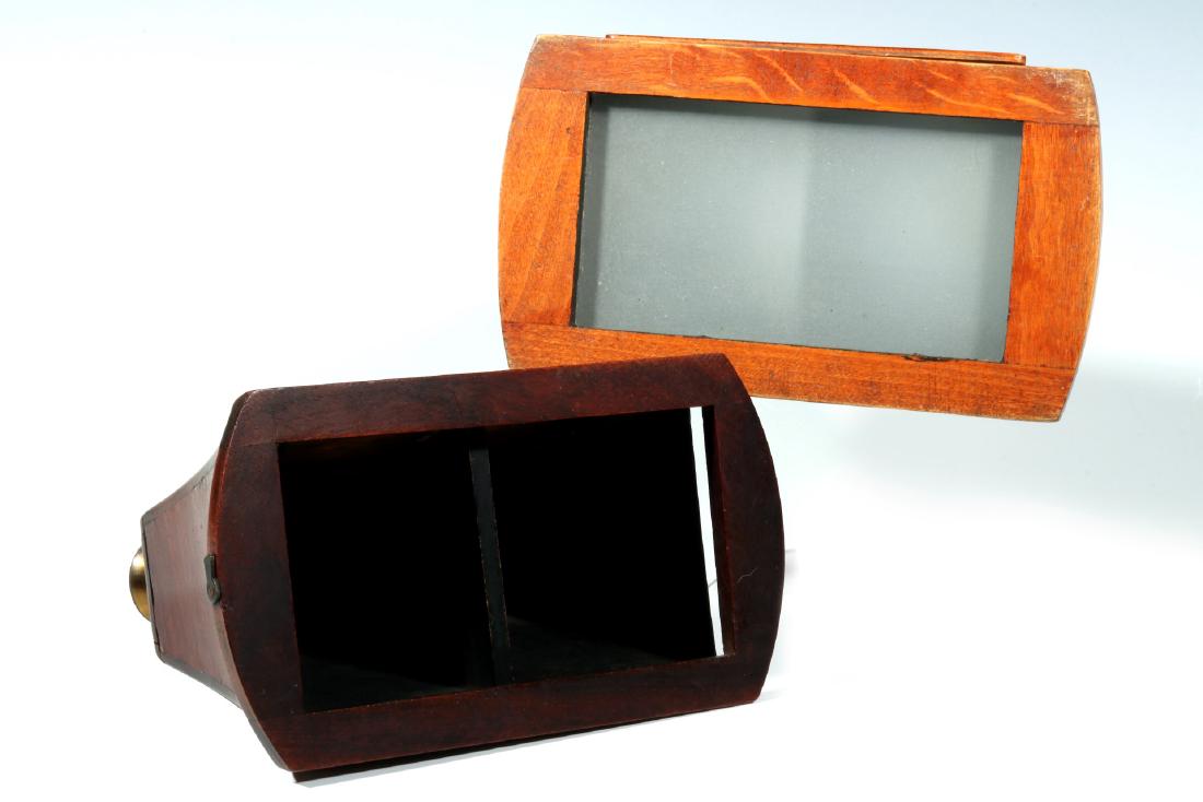 TWO 19TH CENTURY BREWSTER STYLE STEREOSCOPES: Larger mahogany example square oculars, mirror on hinged door, and ground glass light diffuser, measures 6.5 x 4.25 x 7.5 inches. Smaller example in a darker mahogany case, brass binocular style eyepi