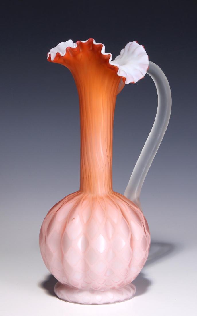 A TALL 19TH C. SATIN APRICOT MOTHER OF PEARL EWER: An apricot-colored satin glass ewer cased in white with slender neck, bulbous melon rib base and diamond quilted internal decoration, applied handle. Measures 11.5 x 6 inches. We happily provide seaml