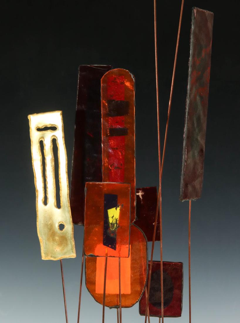 C. JERE MODERNIST KINETIC SCULPTURE: An animated sculpture comprised of colorful confetti plastics and cut brass medallions on long flexible brass rods, dark green painted wood block base, applied oval brass signature tag, circa 1967. He