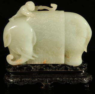 JADE ELEPHANT WITH BLANKET AND RUYI SCEPTER: A carved elephant supporting a relief carved blanket upon its back, a small boy with ruyi scepter atop, displayed on a fine carved stand. Measures 3.25 x 4.5 inches. We happily provide seamless in-hou