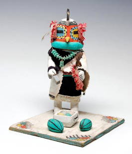 A CIRCA 1950 HOPI COTTONWOOD ROOSTER KACHINA DOLL: A carved and painted cottonwood Rooster katsina, flat square base with watermelon, pencil inscription under the base, 'Chicken kachina'. Measures 8 x 6.25 inches. We happily provide seamless in-house