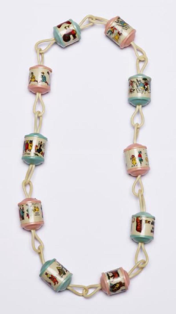 A CELLULOID BABY CHAIN WITH NURSERY RHYMES (1 of 4)