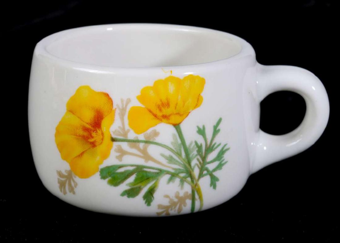 AT&SF SANTA FE CALIFORNIA POPPY COFFEE CUP, SAUCER: Both pieces marked Syracuse, cup coded 99-A, saucer, Y-5. Cup with 'Made expressly for Santa Fe Dining Car Service' in green. Cup measures 2.5 x 4.5 inches, saucer 6 inches in diameter. We happily pro