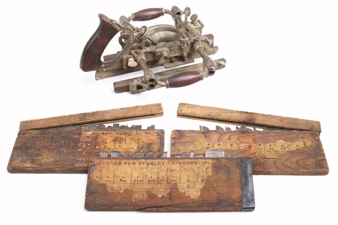 A STANLEY NO. 55 UNIVERSAL PLANE WITH CUTTERS: Combination plane produced 1899-1962, an ornate plane with three sets of cutters in the original storage boxes. Plane measures 10 x 11.5 inches. We happily provide seamless in-house packing and shippi