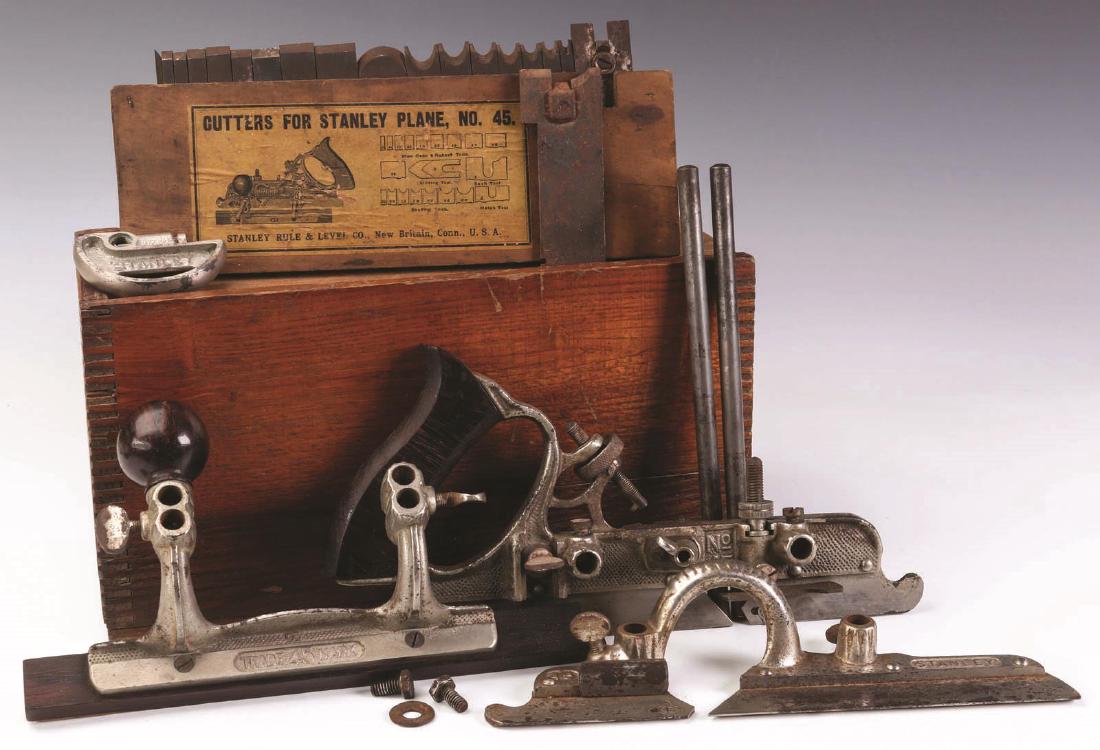 STANLEY PLANE No. 45 WITH ORIGINAL BOX & CUTTERS: A fine plane with boxed cutters and fences. Original old wooden boxes, smaller bearing the original paper label. Plane measures 11.5 inches. We happily provide seamless in-house packing and shipping s
