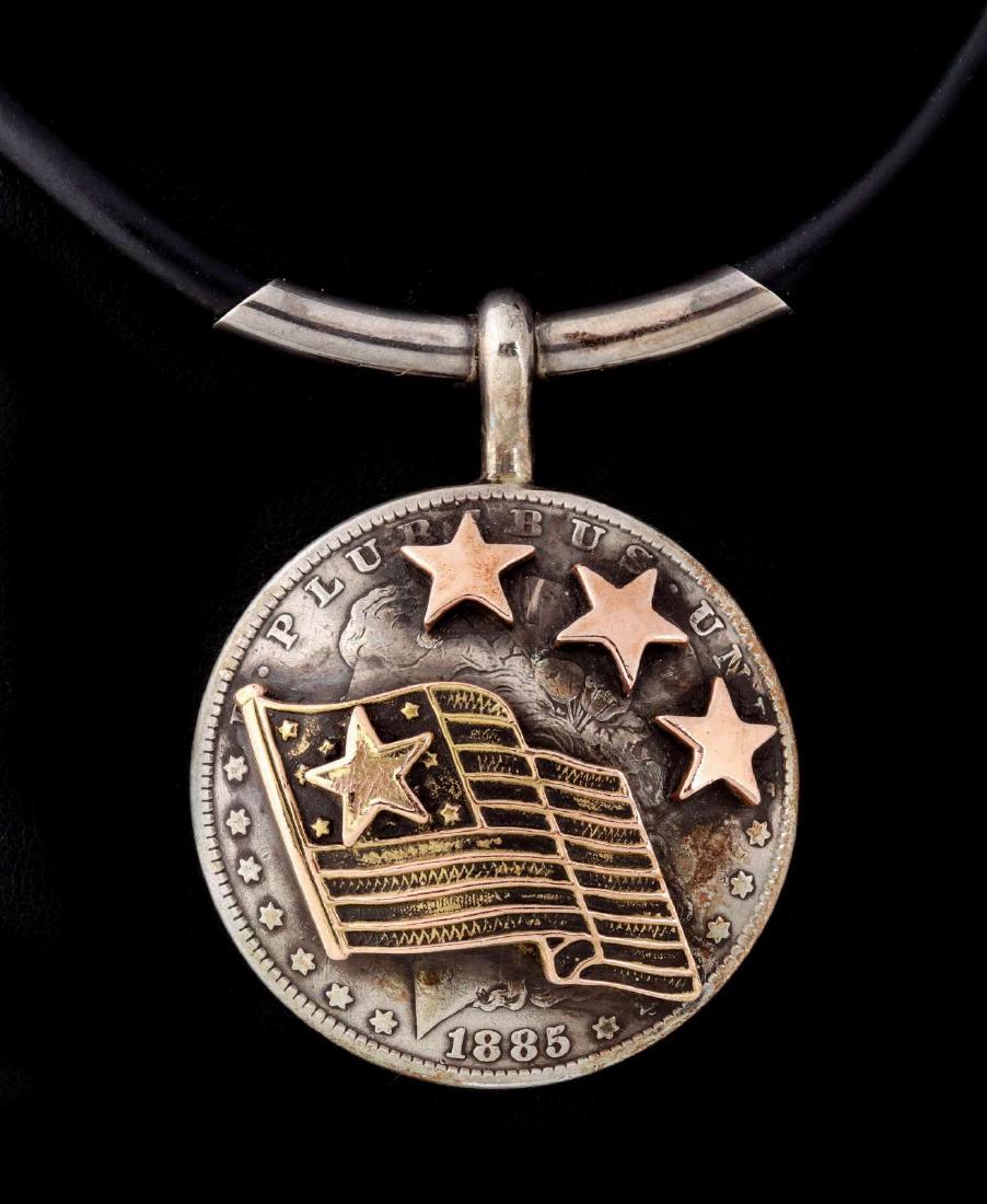 AN ARNOLD GOLDSTEIN SILVER DOLLAR AND 10K PENDANT (1 of 10)