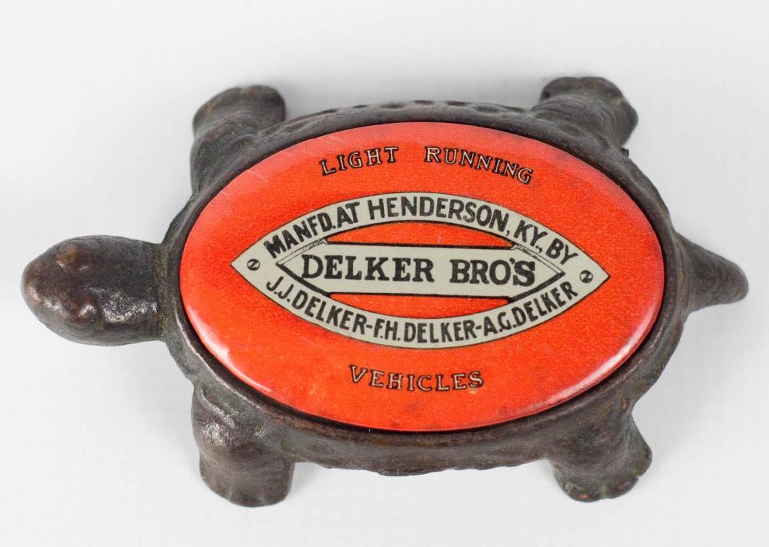 DELKER BROS. KENTUCKY CARRIAGES 1910 ADVERTISING: Iron and celluloid advertising paperweight for Delker Bros. of Henderson, Kentucky, known for manufacturing light vehicles like buggies, coaches and carriages. Measures 4.25 inches. We happily provide