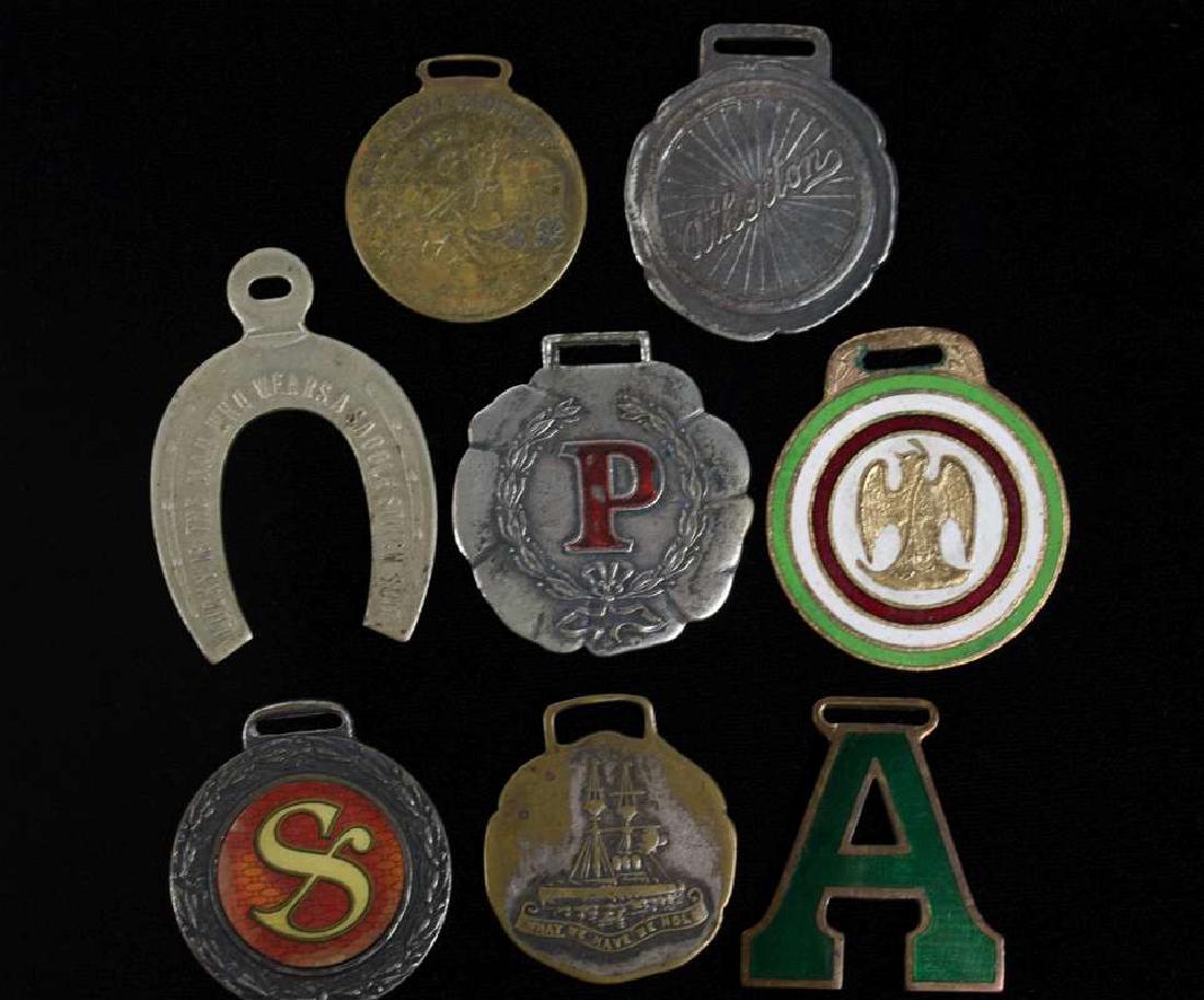 EIGHT VARIOUS ANTIQUE ADVERTISING WATCH FOBS (1 of 4)