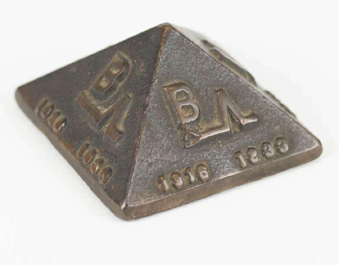 A PYRAMID FORM BRONZE ADVERTISING PAPERWEIGHT (1 of 6)