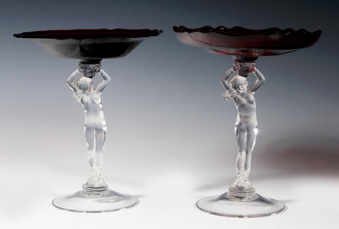 TWO CAMBRIDGE 'STATUESQUE' NUDE STEM COMPOTES: Clear Statuesque stems, flared compote bowl in amethyst, the cupped compote bowl in carmen, both are unsigned. Tallest measures 8.25 x 6.5 inches. We happily provide seamless in-house packing and ship