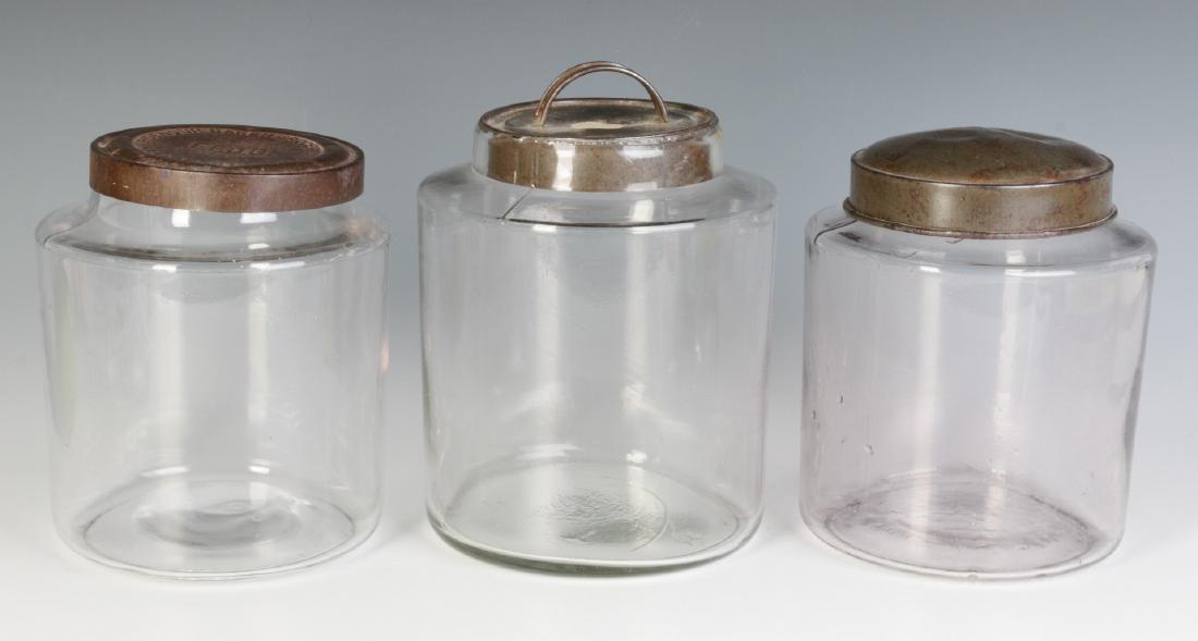 THREE EARLY BLOWN GLASS STORAGE JARS WITH TIN LIDS (1 of 6)