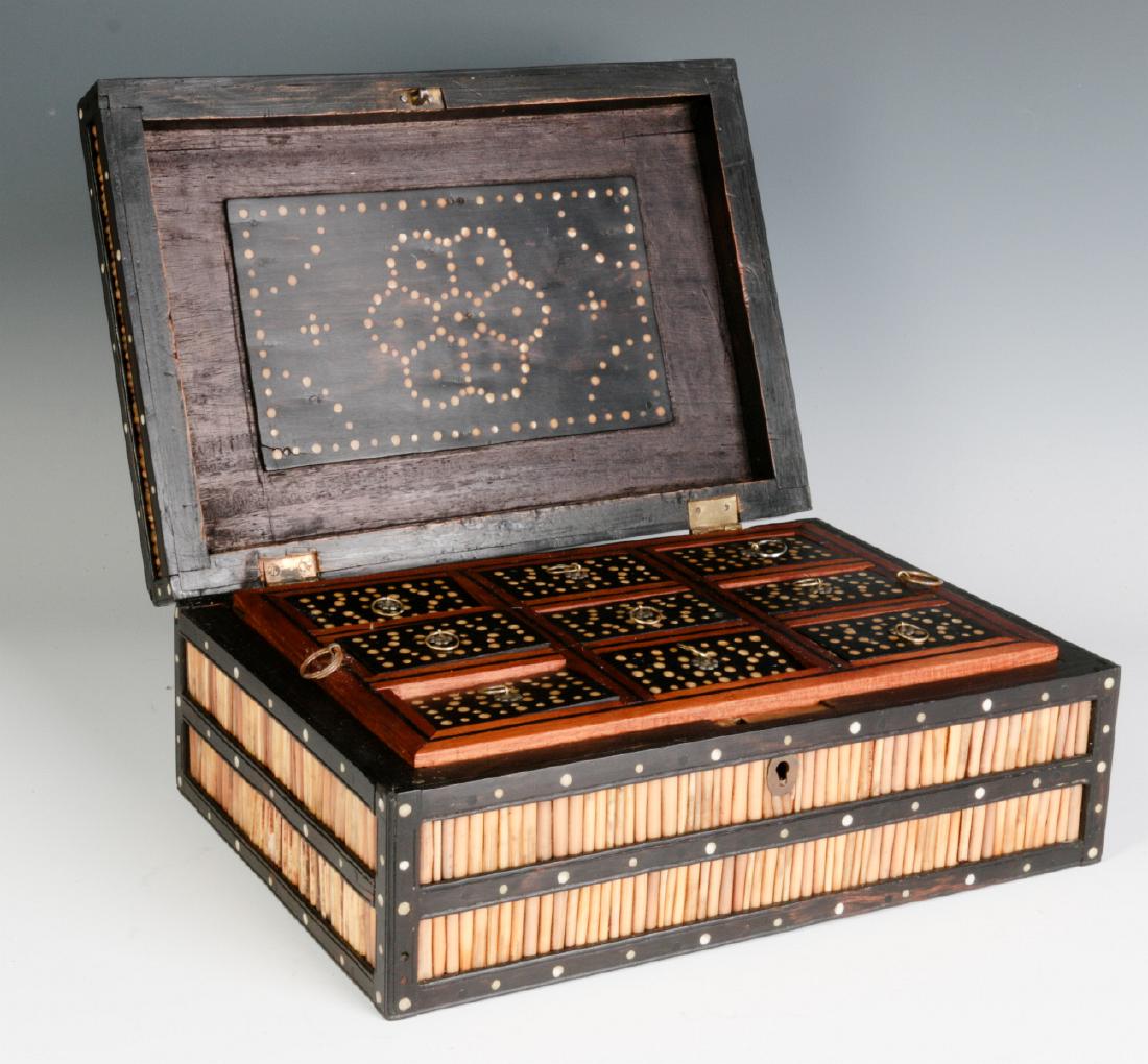 AN ANGLO-INDIAN QUILL BOX WITH DIVIDED INTERIOR: A good early 20th century example, the case overlaid with a frame of ebony woods set with porcupine quills in panels divided by wood lattice inlaid with bone, the interior fitted with an unusual lift-