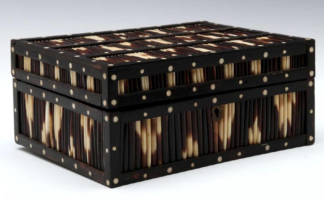 AN ANGLO-INDIAN INLAID PORCUPINE QUILL TRINKET BOX: The mahogany case overlaid with a frame of ebony woods set with porcupine quills in panels divided by wood lattice inlaid with bone, an additional inlaid decorative plaque inside the lid. Measures 3.5