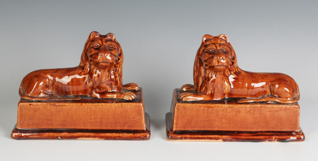 A PAIR BRITISH STONEWARE RECUMBENT LION FIGURES (1 of 4)