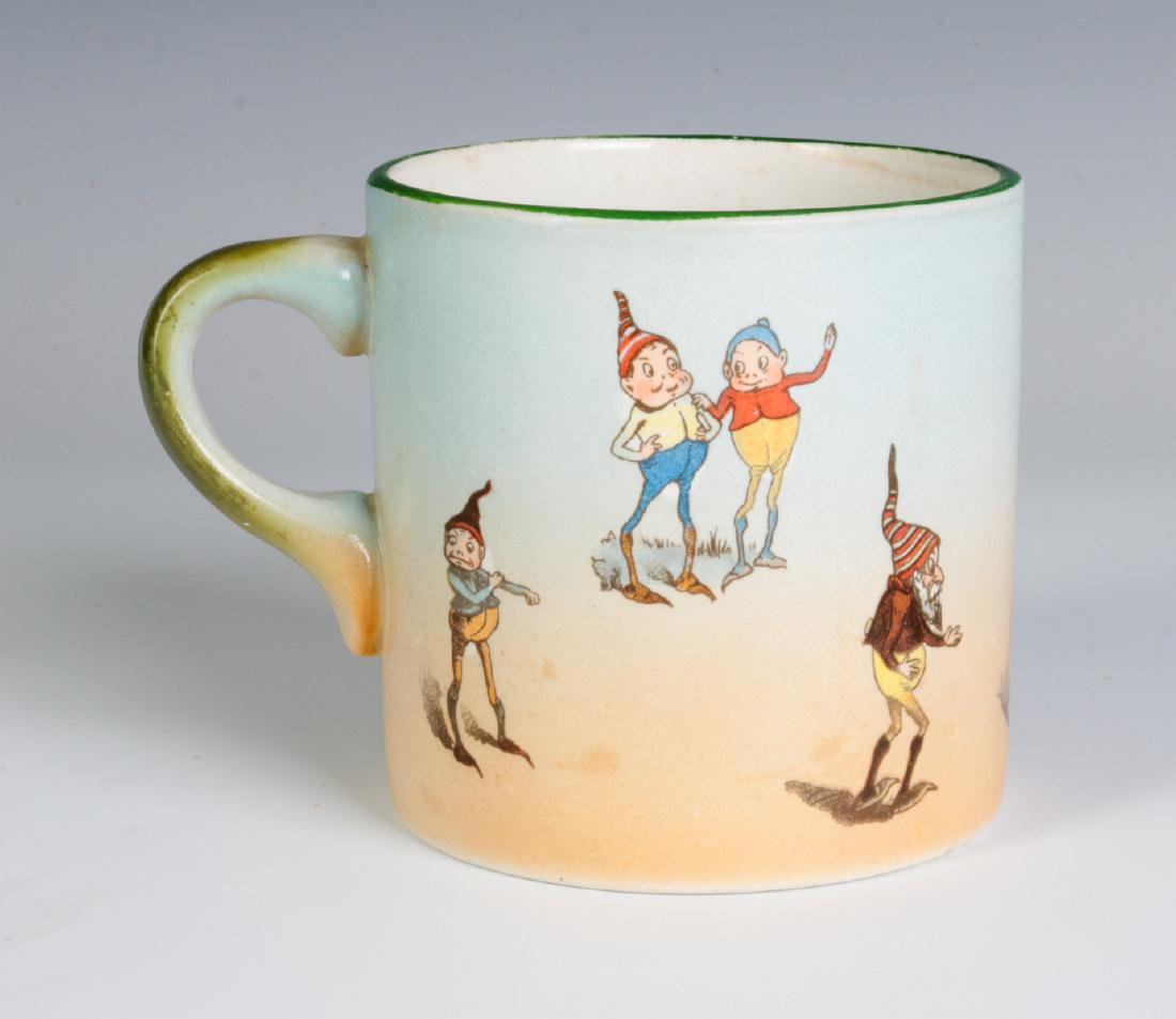 A GRIMWADE'S WINTON PALMER COX BROWNIES MUG: An English pottery mug decorated with transfers of fairy-like sprites of the type popularized by the illustrator and author Palmer Cox, circa 1883, this piece circa 1910. Measures 3.5 x 4.75 inches. W