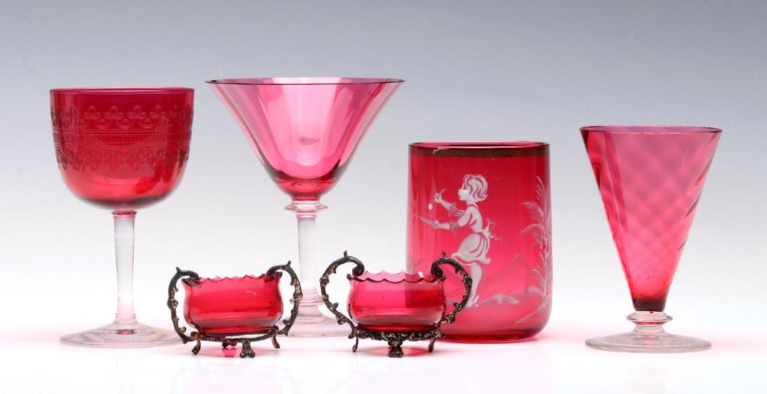 A COLLECTION OF STEUBEN AND OTHER CRANBERRY GLASS: An etched cranberry stem, a wine attributed to Steuben ,two Victorian salts in metal stands, a Mary Gregory type tumbler and a stem attributed to Steuben. Smallest to largest measures 1.5 x 2.25 inche