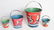 FOUR VARIED SIZE CHILD'S TIN LITHO SAND PAILS