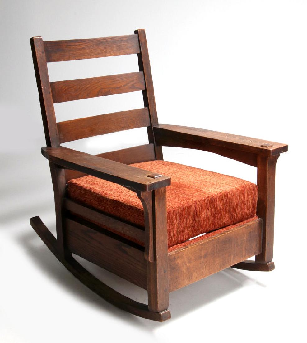 AN OAK ARTS & CRAFTS ROCKING CHAIR SIGNED LIFETIME: Model number 643, four horizontal back slats. peg construction, flat mortised arms, drop-in seat, paper label. Measures 38 x 31 x 36 inches. We happily provide seamless in-house packing and shipping s