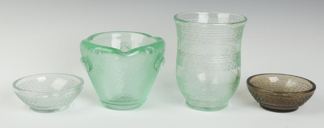 CIRCA 1930s ART GLASS BY DAUM, NANCY: Four pieces total, signed 'Daum, Nancy' on the bowls and heavy green vase. Smallest to largest measures 1.5 x 4 inches to 5.25 x 4 inches. We happily provide seamless in-house packing and shipping ser