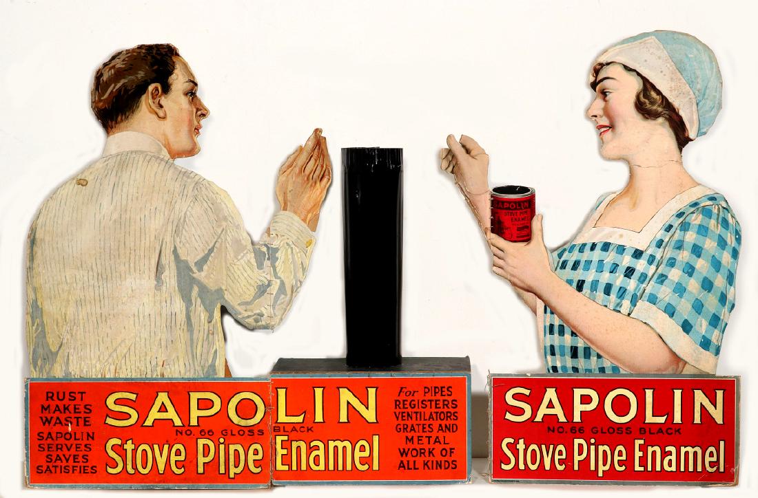DIE-CUT SAPOLIN PIPE ENAMEL DISPLAY W/ STOVE PIPE: A die-cut stove pipe display for SAPOLIN Gloss Black Stove Pipe Enamel, a circa late 1920s gentleman and lady standing either side of a circular stove pipe and considering the application of Sapolin e
