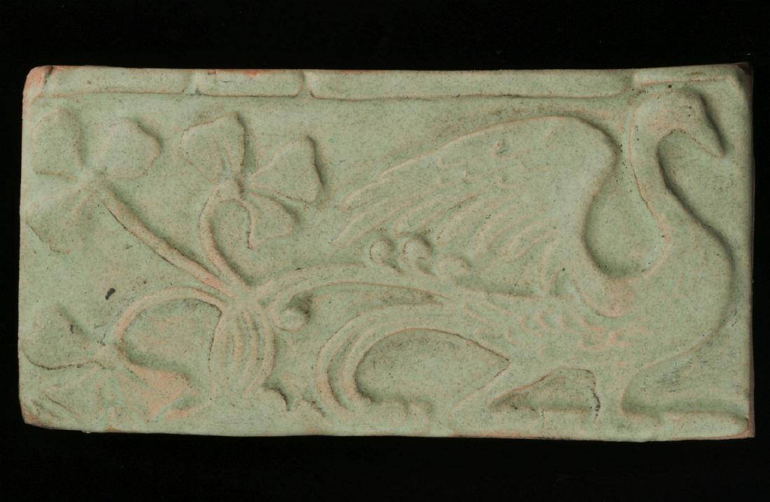 A GOOD CARVED TERRA COTTA TILE, MATTE GREEN GLAZE: Decorated with a stylized phoenix, green matte glaze, unsigned. Measures 4 x 7.5 inches. We happily provide seamless in-house packing and shipping services on nearly everything we sell.
