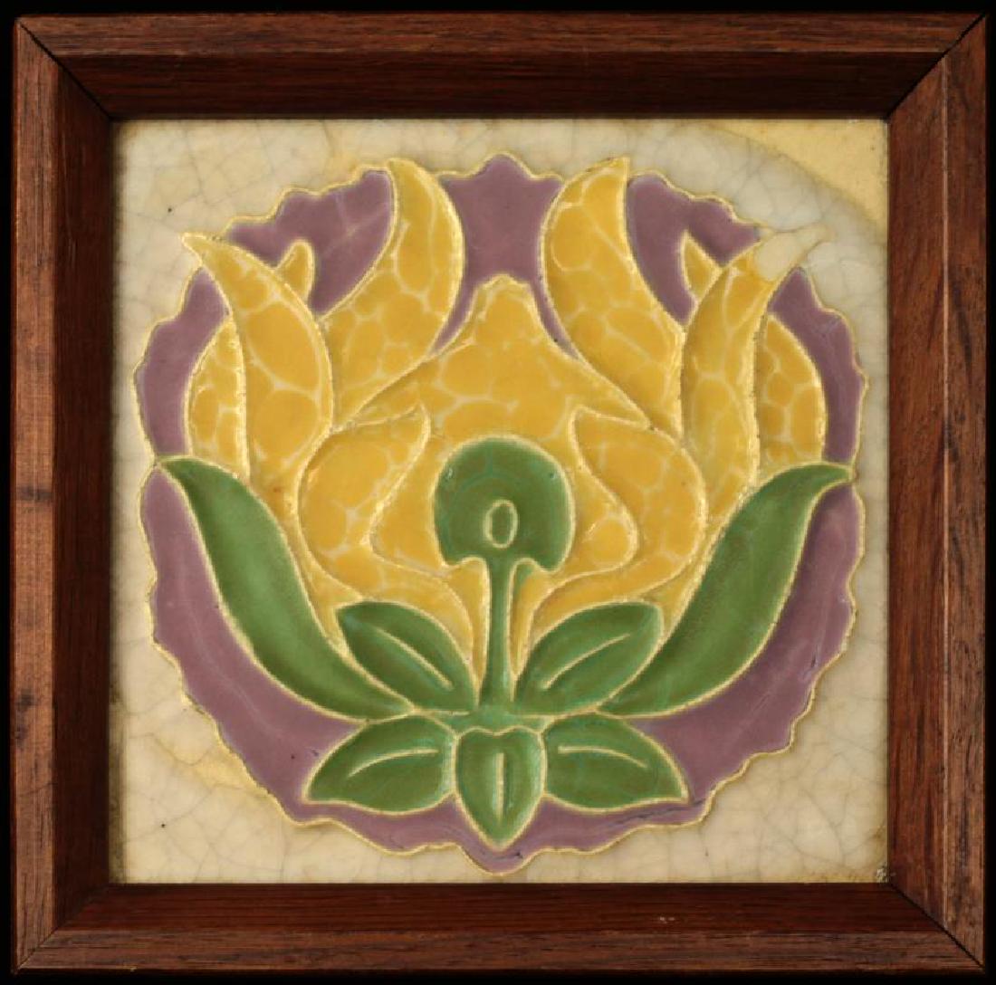 ROOKWOOD TUBE-LINED ARTS AND CRAFTS INFLUENCE TILE: The central flower head design centered by a flower head in interesting curdled glazes surrounded by crackle glaze, signed by impressed maker's cipher along with various numerals. Measures 7 x 7 inche