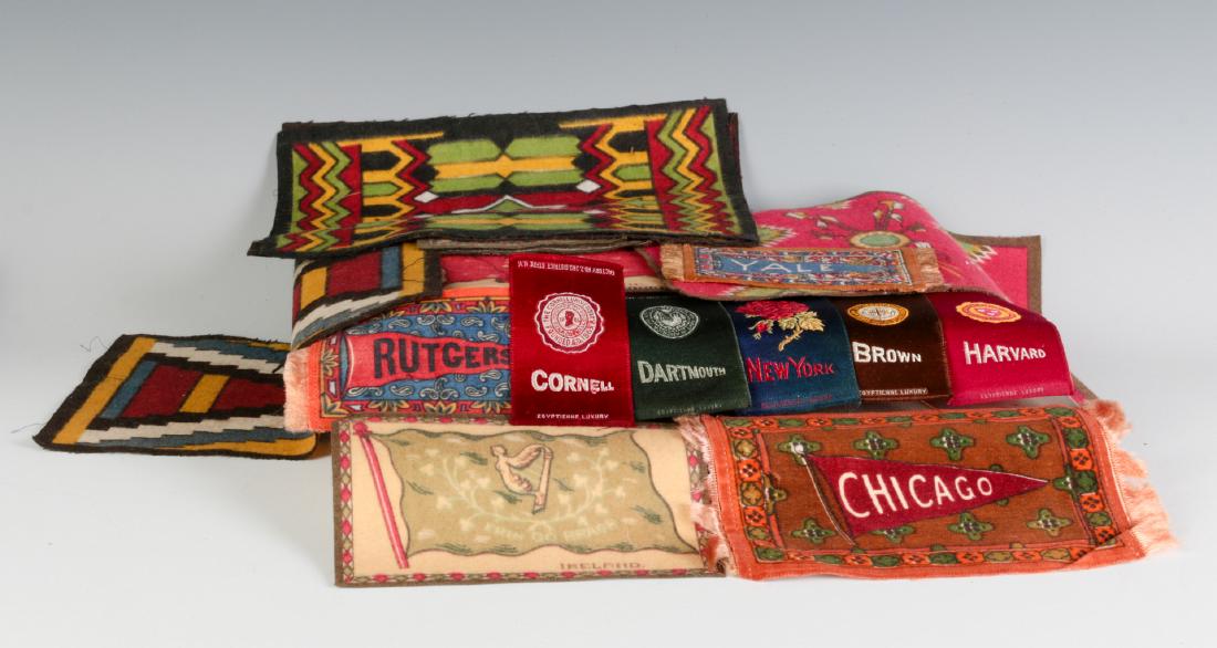 A COLLECTION OF TOBACCO SILKS AND FLANNELS: College pennants and seals, nation flags, etc. Largest examples measure 6 x 8.5 inches. We happily provide seamless in-house packing and shipping services on nearly everything we sell.