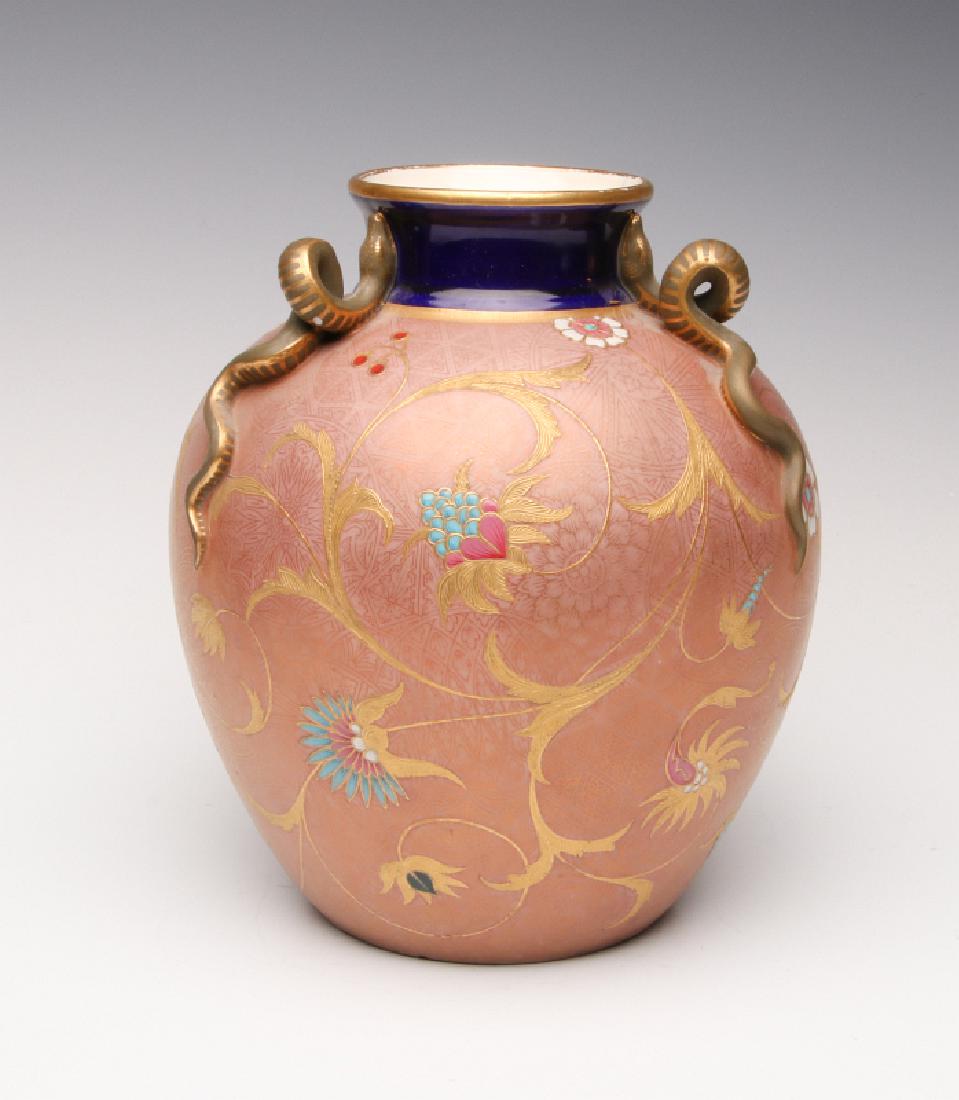AN 1879 WORCESTER ENAMEL VASE WITH FIGURAL SNAKES: A Royal Worcester vase, date mark for 1879, unusual salmon-colored background, cobalt collar, gold enamels with jewel tone enamel embellishment. 1879 date mark. Measures 8.5 x 7 inches. We happily pro