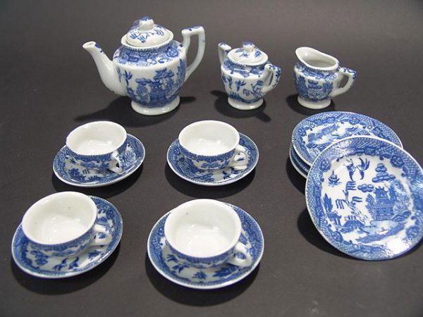 CHILD'S OCCUPIED JAPAN TEA SET - BLUE WILLOW: Teapot measures 3 3/4" tall by 4 1/2" wide. Creamer is 1 7/8" tall by 2 1/2" wide. Sugar is 2 1/2" tall by 3" wide. Cups are 1" tall by 2 1/4" wide. Saucers are 2 7/8" in diameter and plates are 3 3/8