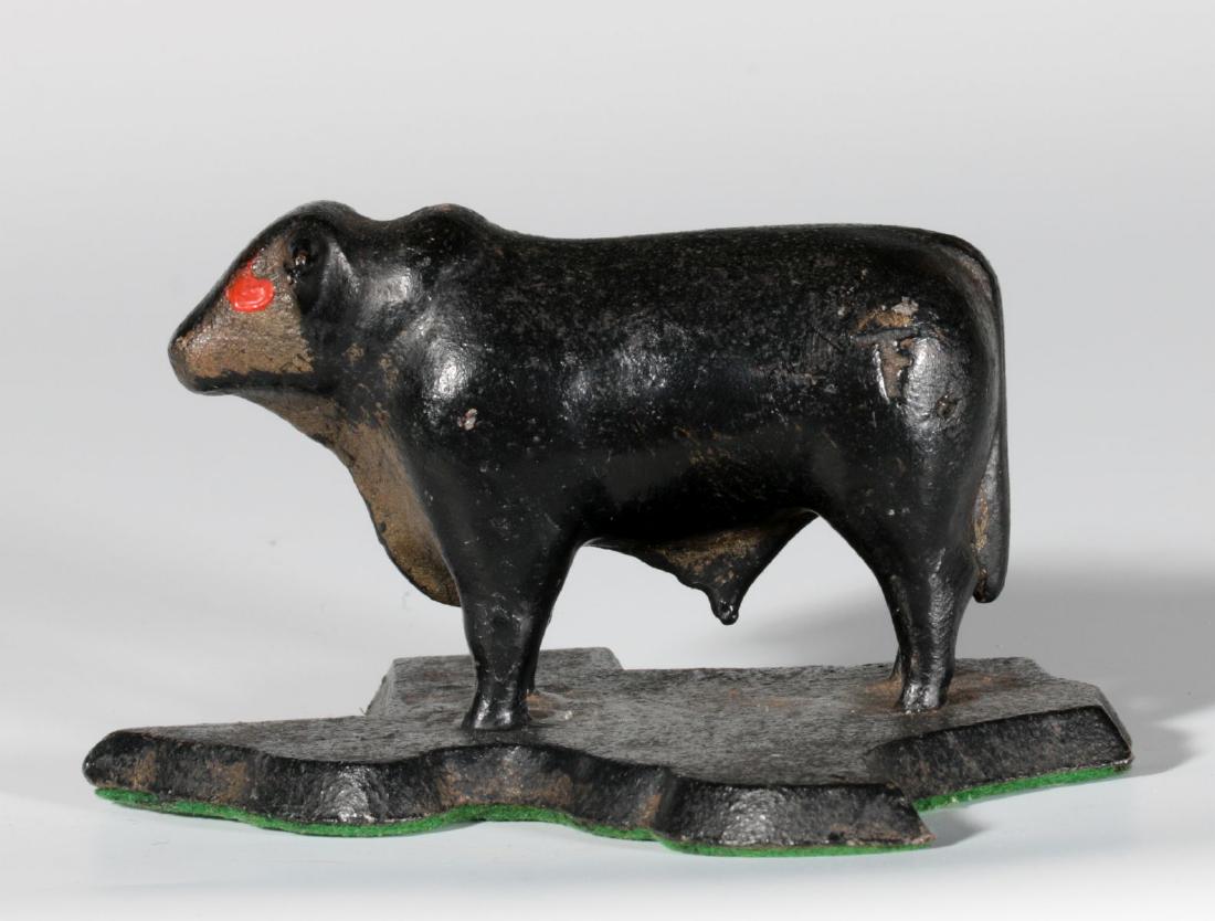 A CAST IRON PAPERWEIGHT - FIGURAL BULL ON TEXAS (1 of 6)