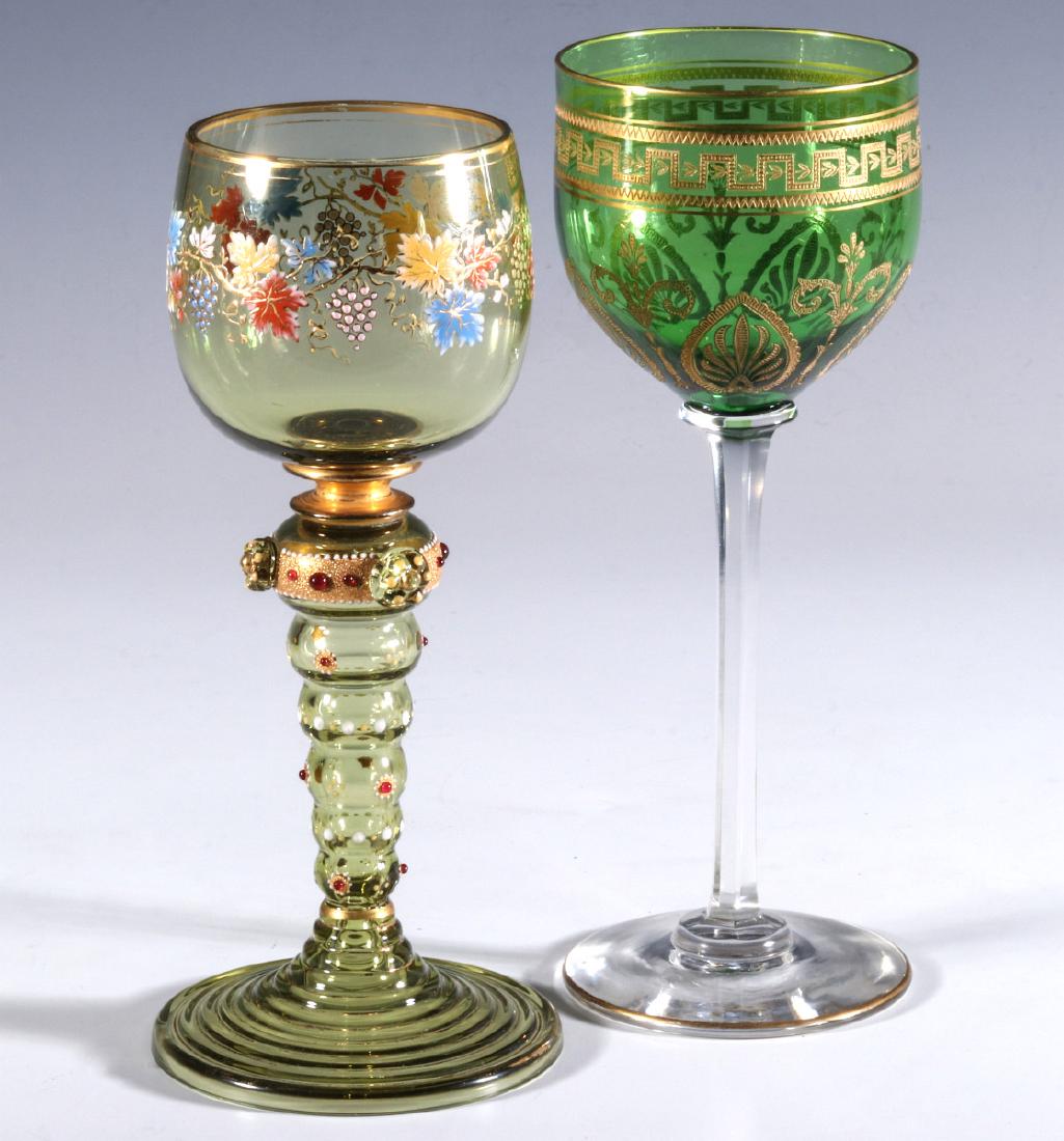 BOHEMIAN AND FRENCH(?) ART GLASS WINE GOBLETS: Two goblets with enamel decoration, one with grapes, applied glass bead 'jewels.' applied prunts and gold trim all raised on a concentric ring stem; plus a more emerald green goblet with intricate inc