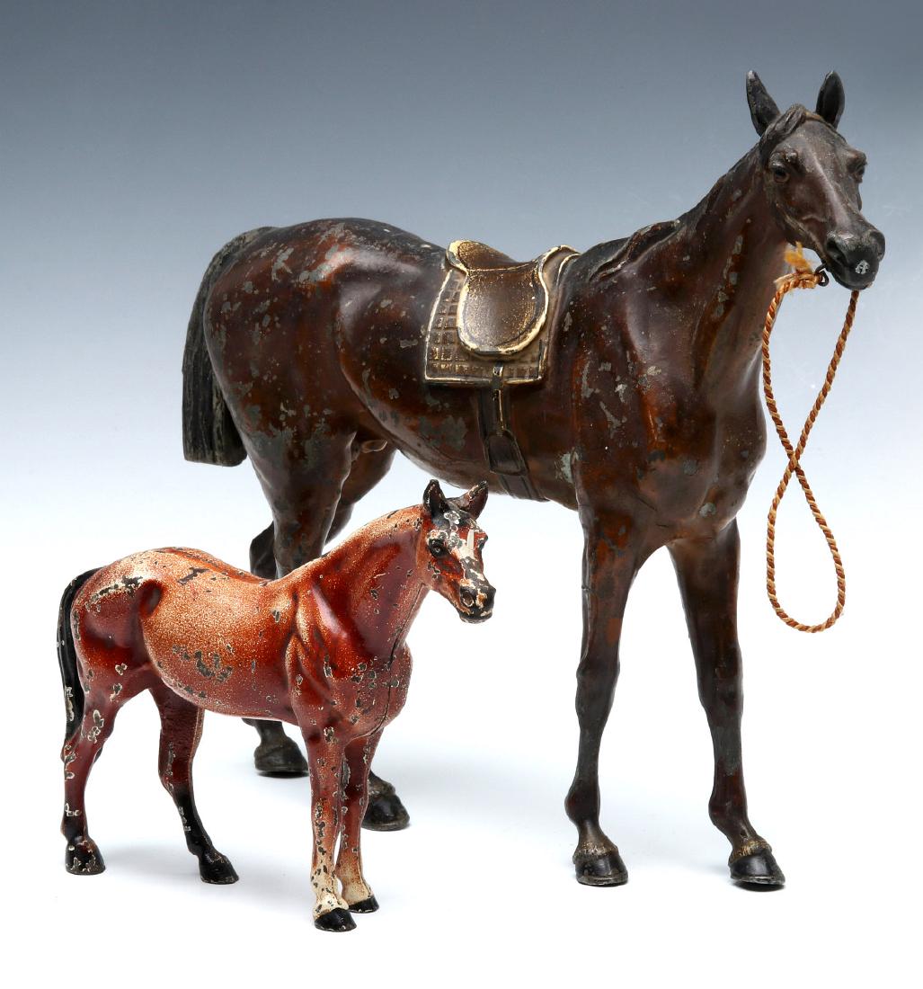 TWO CAST IRON FIGURAL HORSE DOORSTOPS INCL HUBLEY: Includes: A small three-dimensional Hubley horse doorstop, two piece construction with a slotted screw, signed 'Made in USA' on the left rear leg, Hubley design number 325, no wooden base; and A large