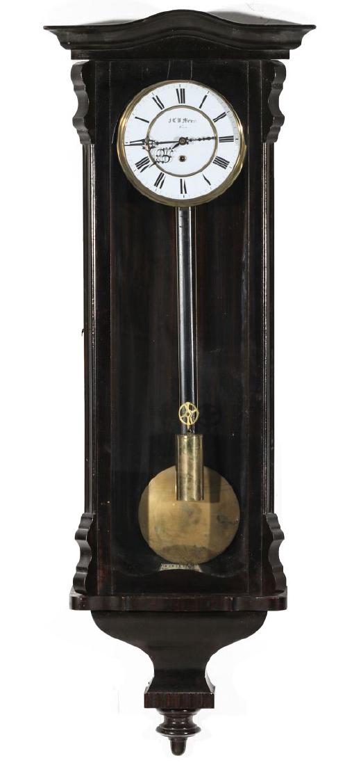 A J.C.W. MEYER, VIENNA ONE WEIGHT WALL REGULATOR: A 19th century Austrian clock, ebonized wall hanging case, enameled dial with Roman numerals, filigree hands, one weight, a single winding aperture, signed on the face. Measures 41.5 x 15 x 6 inches.