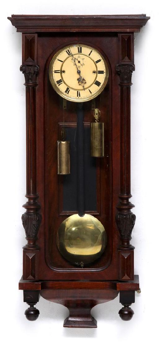 A TWO-WEIGHT VIENNA REGULATOR WALL CLOCK: A 19th century wall mounted regulator with a wooden case, turned wood half-columns and finials, enameled dial with Roman numerals and seconds bit, filigree hands, two weights, eight day, time and stri