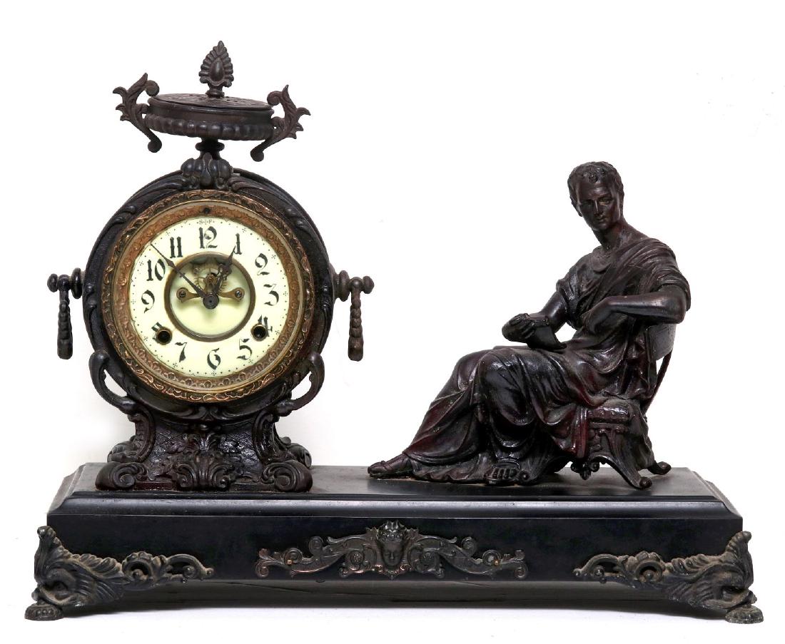 A NEW HAVEN SEATED STATUE CLOCK: A New Haven 'Seated Statue' clock, porcelain dial, exposed escapement, pendulum present, two winding apertures. Measures 16 x 20 x 6.5 inches. We happily provide seamless in-house packing and shipping