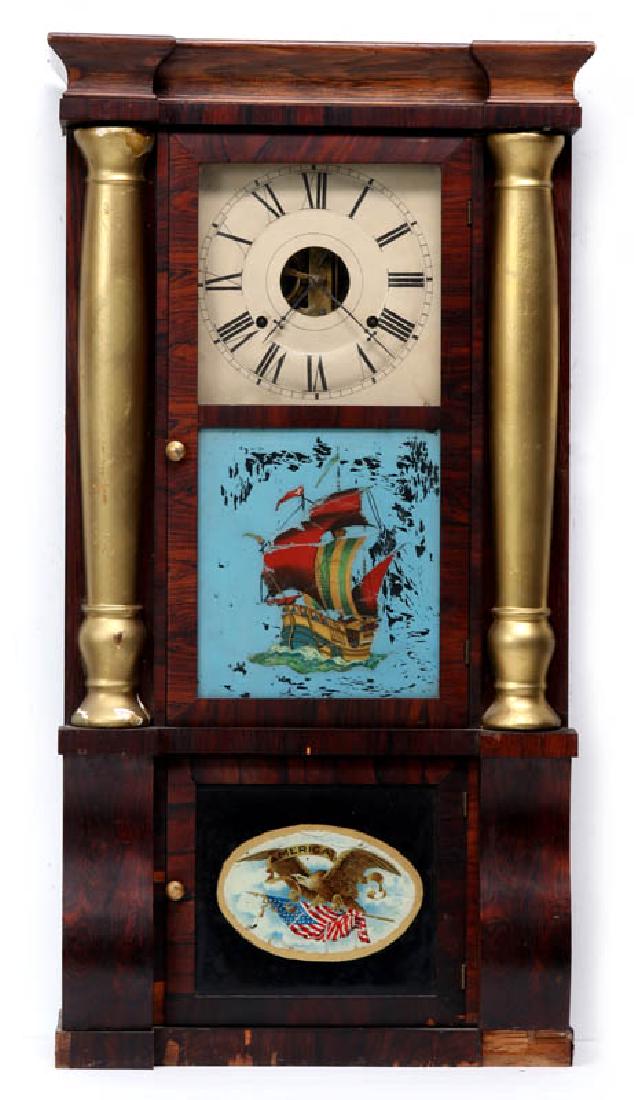 SETH THOMAS EMPIRE STYLE TRIPLE-DECKER CLOCK: A Seth Thomas clock, double doors with sailing ship over a Federalist eagle, half turned wood columns, Roman numeral dial, movement signed 'Seth Thomas.' Measures 33 x 17.25 x 5.5 inches. We happily p
