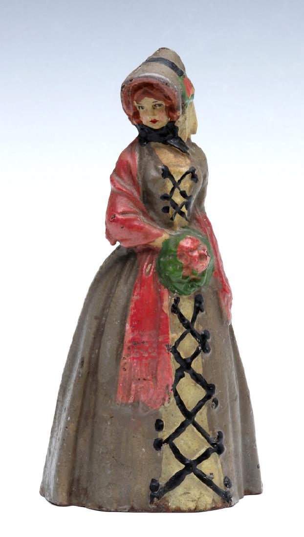 NATIONAL FOUNDRY VICTORIAN LADY CAST IRON DOORSTOP: A circa 1920s three-dimensional polychrome doorstop, solid cast iron construction, by National Foundry design number 67, unsigned. Measures 6.75 x 3.25 x 2.5 inches. We happily provide seamless in-hou