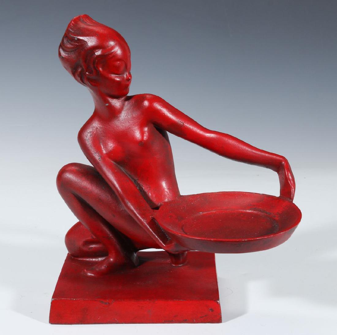 AN ART DECO NUDE STATUETTE SIGNED FRANKART: A spelter sculpture by Arthur von Frankenberg (1898-1992) for 'Frankart Inc., red finish, a kneeling female nude figure holds a tray, signed on the base. Measures 9.5 x 8 x 4.25 inches. We happily pro