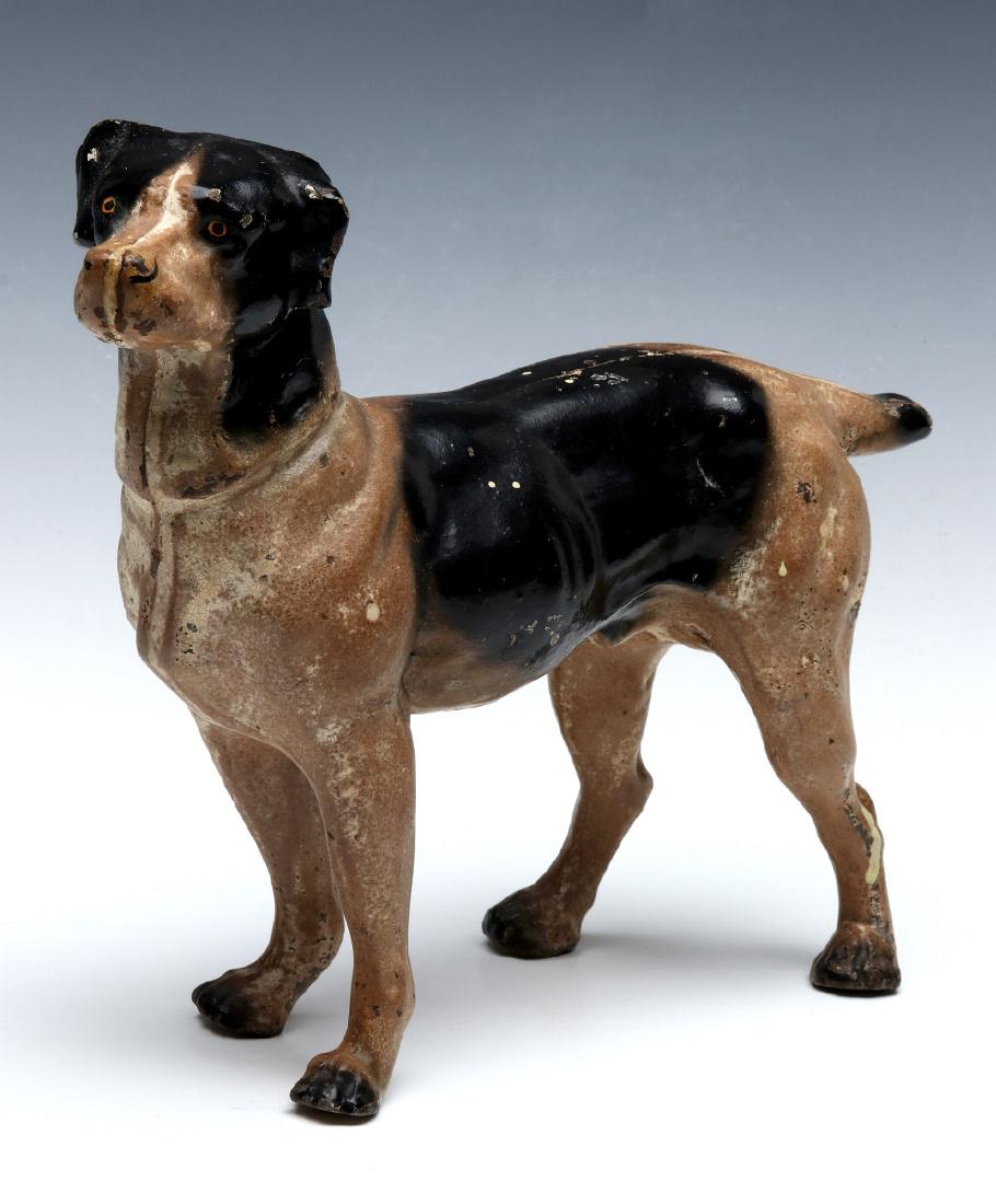 A HUBLEY CAST IRON DOG DOORSTOP: A three-dimension polychrome doorstop, two piece construction with a slotted screw, unsigned. Measures 8.5 x 10.5 x 2.75 inches. We happily provide seamless in-house packing and shipping services on n