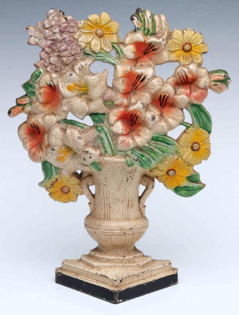 A HUBLEY GLADIOLUS CAST IRON DOORSTOP NO. 489: A single-sided polychrome doorstop, Hubley 'Gladiolus' #489, marked on the back. Measures 10 x 8 x 3 inches. We happily provide seamless in-house packing and shipping services on nearly everything we 